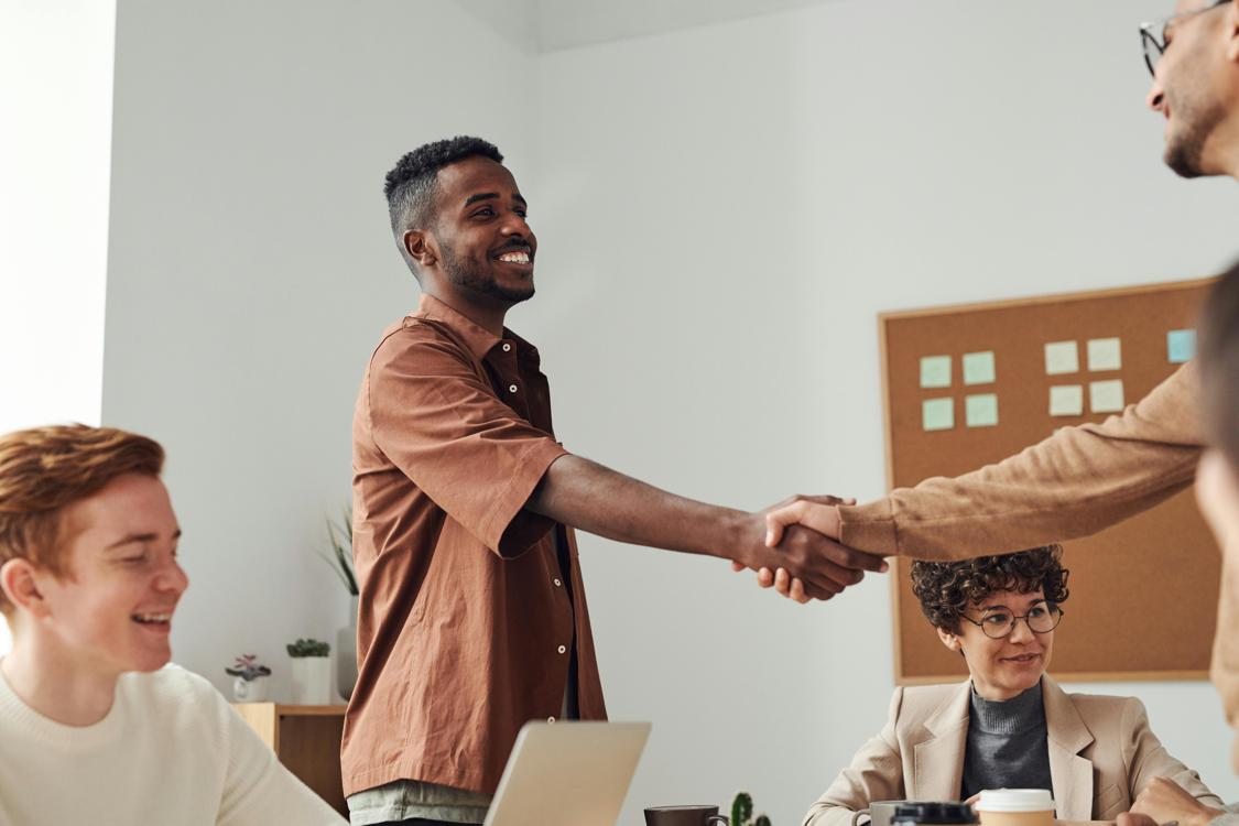 man in brown sport shirt shaking hands of man - How to Interpret Dreams About Rings and Commitment